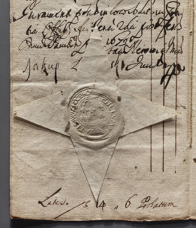 Round dry impression of the town seal of Wachock. Depicts a city wall with three towers, flags on