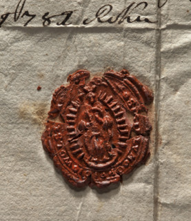 Oval wax impression of the seal of the town of Wolsztyn. In an oval rim with rays, the Virgin Mary