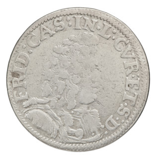 Obv. In the border a male bust in armor and a wig turned to the right, separating the inscription