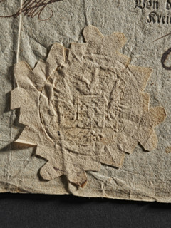 Dry impression of an official seal; coat of arms with wings and two eagle heads with crowns, 1802,