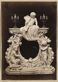 Photograph of a sculpture by Wiktor Brodzki showing a neo-rococo fireplace frame with three putti;