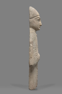 Fragment of a votive figure of a man. The fragment depicts a standing man dressed in a tutulus and