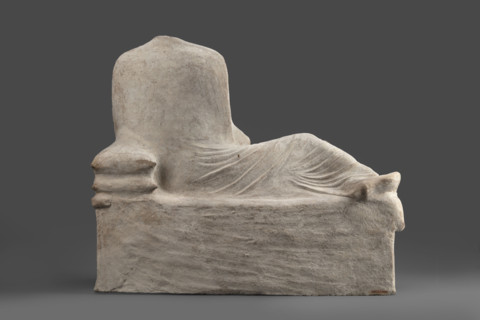 Depiction of a deceased person on a keline and a servant; banquet scene, Cypriot sculpture. The