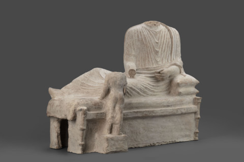 Depiction of a deceased person on a keline and a servant; banquet scene, Cypriot sculpture. The
