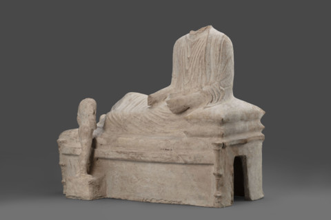 Depiction of a deceased person on a keline and a servant; banquet scene, Cypriot sculpture. The