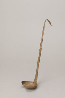 Shallow dipper with a quadrilateral handle, narrowed at the top. The end of the handle is in the