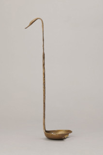 Shallow dipper with a quadrilateral handle, narrowed at the top. The end of the handle is in the