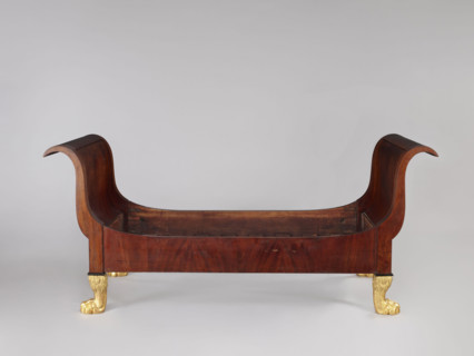 Bed with animal-paw legs in Empire style for bedrooms. Mahogany bed with S-shaped outward-curving