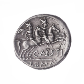 Denarius, obverse head of Roma in helmet at right; behind her a dog; in front of her a sign of