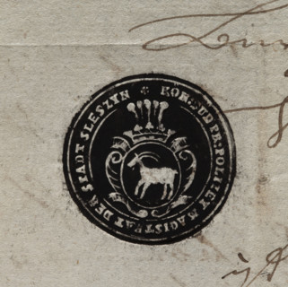 Round ink print of the seal of the town of Sleszyn. In a baroque cartouche, under an open crown