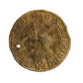 Obv.: A standing figure in armour turned right with a sword at his left side, right hand on hip,