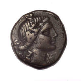 bronze coin, Pantikapaion; obverse: head of young Dionysus in ivy wreath facing right; reverse: bow