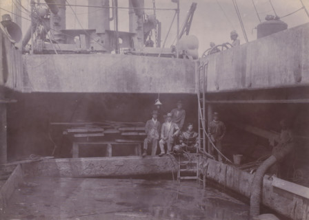 Japanese divers on hold II, photograph, A Japanese diving team poses at the edge of the hold of a