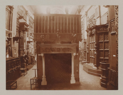 View of a hall with a fireplace and reliefs, album page, photograph, This album page is part of a