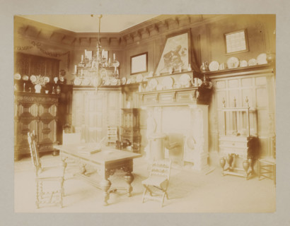 Interior with a desk, chairs and decorative plates, album page, photograph, This album page is part