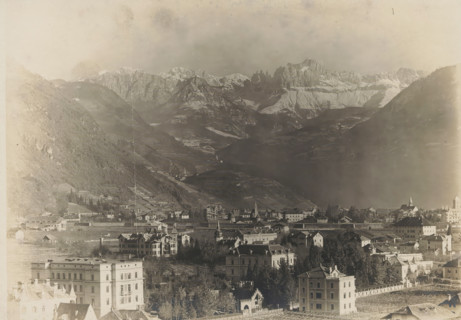 Landscape with mountains and a city, album page, photograph, This photo is part of an album.,