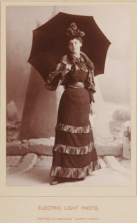 Electric Light Photo, Portrait of an unknown woman with an umbrella, photograph, page, inscription: