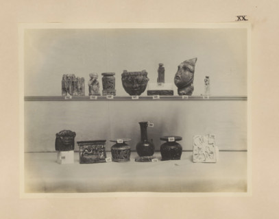 Fourteen Egyptian objects, including a sculpture of Harpocrates and four cabbage pots, photograph,