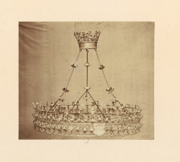 Two metal candlesticks with bases, displayed at an exhibition of religious objects from the Middle