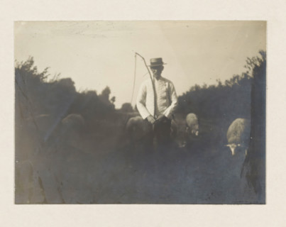 Man in white coat, photograph, possibly a coachman or an angler. Part of the loose-leaf photo album