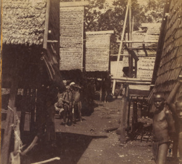 View of a village street with groups of children on one of the Tanimbar Islands, Tenimber Islands.