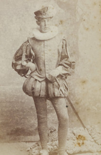 Portrait of a young man in costume, identified as HM Hijmans, album page, photograph,