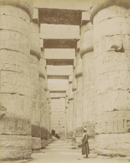 Temple of Karnak, Thebes (Luxor), Man in a colonnade with hieroglyphs (former title), photograph,