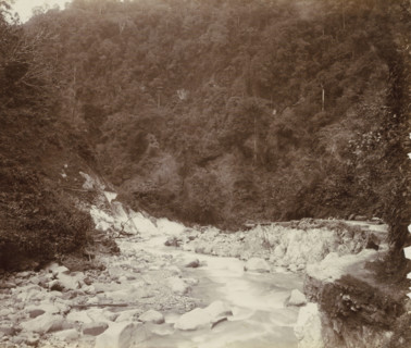 Stream with a road alongside it and workers in the Dutch East Indies, album page, photograph, Part