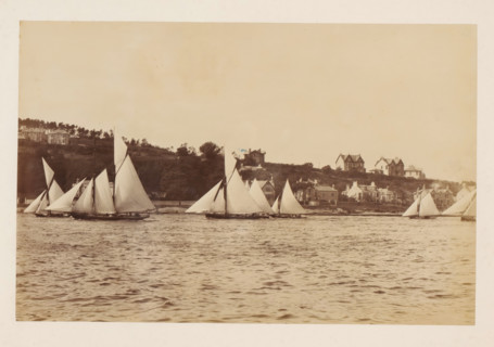 Various sailing ships on the water with buildings in the background, album page, photograph, This