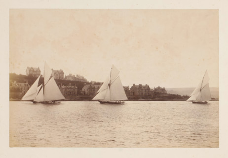 Sailing ships Yvonne, Doris and Darthula in the water with buildings in the background, album page,