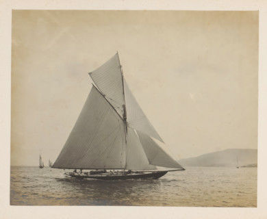 Sailing ship the Queen at sea with other sailing ships and a hill in the background, album page,