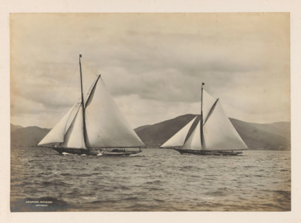 Sailing ships Meteor and Iverna at sea with a hilly landscape in the background, album page,