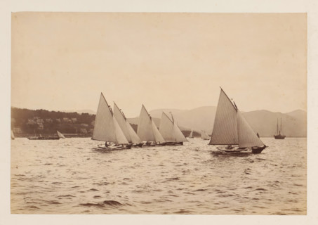 Various sailing ships on the water with a hilly landscape in the background, album page,