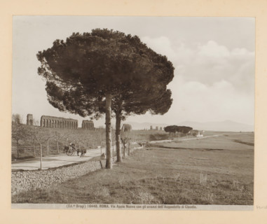 View of the Via Appia Nuova near Rome, with the ruins of the Aqua Claudia, ROMA, in the background.