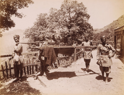 Four Indian men in unform life a palanquin, India, photograph, signature: 'SH Dagg', inscription: