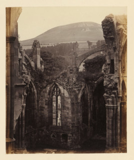 View of a chapel of the ruins of Melrose Abbey with Eildon Hill in the background, photograph,