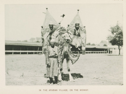 In the Arabian village, on the Midway, Three men with a camel at the World's Columbian Exposition