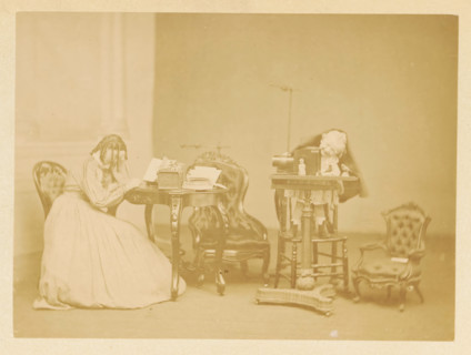 A little boy plays at a table, while a girl reads at another table, photograph, page, photographer: