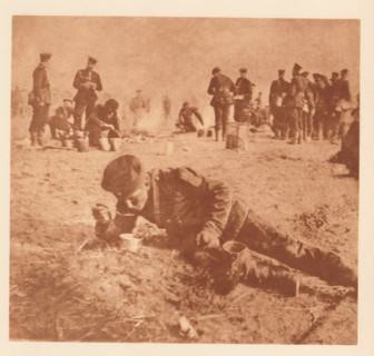 Soldier eating in a reclining position, page, photomechanical print, photographer: Th. Schneider,