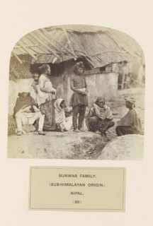 An unknown family on the street in front of houses from the Sunuwar tribe of Nepal, photograph,
