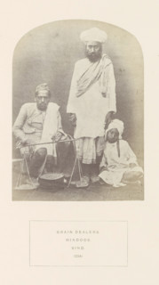 Portrait of three unknown grain dealers in Sindh, Pakistan, photograph, page, inscription: 'GRAIN