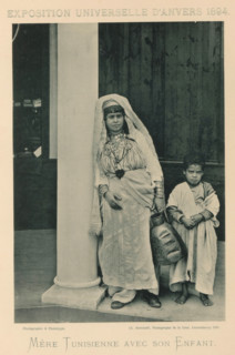 Mother and son in front of a building in the Tunisian part of the Antwerp World Exhibition in 1894,