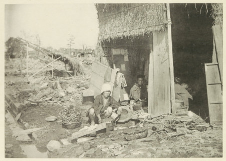 Temporary house in a village in Japan destroyed by an earthquake, page, photomechanical print,