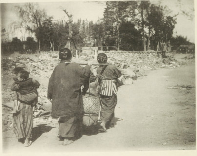 Two women carry belongings on a road in Japan after an earthquake, page, photomechanical print,