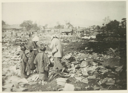 Two women with children stand among the destruction in Japan after an earthquake, page,
