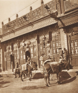 Unknown persons and two donkeys in front of a shop in Beijing, page, photomechanical print,