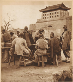 Group of unknown men, some of whom smoke pipes, page, photomechanical print, photographer: Donald