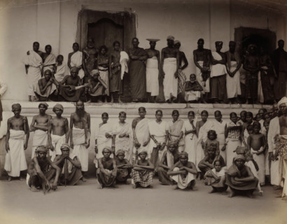 Men and women posing in front of a building, possibly in Ceylon, album page, photograph, Part of