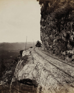 Train runs along a precipice at Sensation Rock in Ceylon, Sensation Rock. Colombo and Kandy Line.,