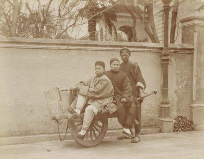 Three Chinese people in Shanghai use a wheelbarrow as a means of transport, album page, photograph,